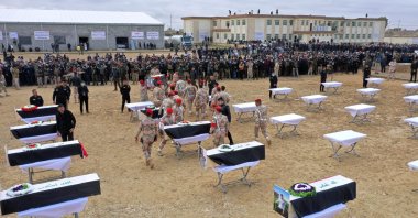 Mourners prepare to bury the remains of Yazidi victims in a cemetery in Sinjar, Iraq, Feb. 6, 2021. (AP File Photo)