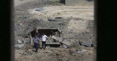 Palestinians inspect the rubble of an ice factory and mechanics garages destroyed by Israeli airstrikes, in Gaza City, Palestine, May 11, 2021. (AP Photo)