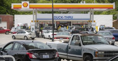 Customers fill up their vehicles with fuel at the Cupboard Food Store (foreground) and the Duck-Thru across in Scotland Neck, North Carolina, U.S., Tuesday, May 11, 2021. (AP Photo)