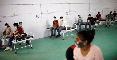 Medical workers sit on beds as they listen to a doctor during their briefing at the site of a temporary coronavirus care facility, at Ramlila Ground, in New Delhi, India, May 12, 2021. (Reuters Photo)