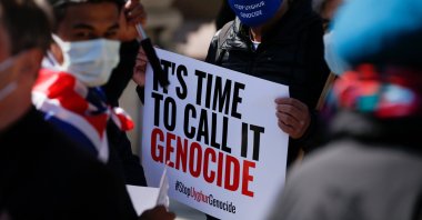 Demonstrators hold placards during a protest against Uyghur genocide in London, U.K., April 22, 2021. (AA Photo)