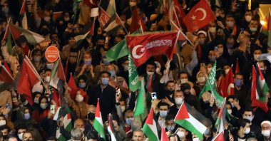 This file photo shows protesters holding Palestine and Turkish national flags and chant slogans during a demonstration outside the Israel Consulate General in Istanbul, Turkey, late on May 10, 2021. (AFP Photo)