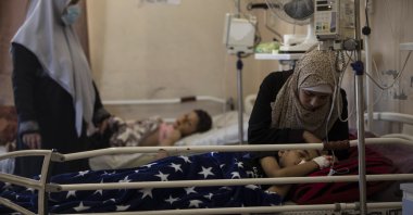 A mother comforts her child receiving treatment at the Shifa hospital in Gaza City, May 13, 2021. (AP Photo)
