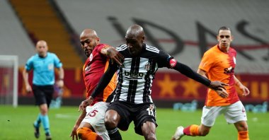 Galatasaray's Marcao (L) and Beşiktaş's Atiba Hutchinson compete for the ball during a Turkish Süper Lig match at Türk Telekom Arena in Istanbul, Turkey, May 8, 2021. (IHA Photo)