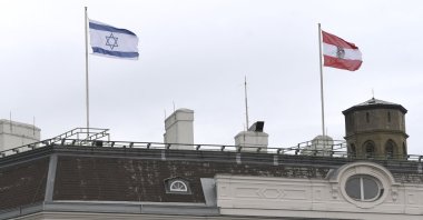 The Austrian Federal Chancellery raised the Israeli flag (L) as a sign of solidarity, in Vienna on May 14, 2021. (Helmut Fohringer/APA via AFP)