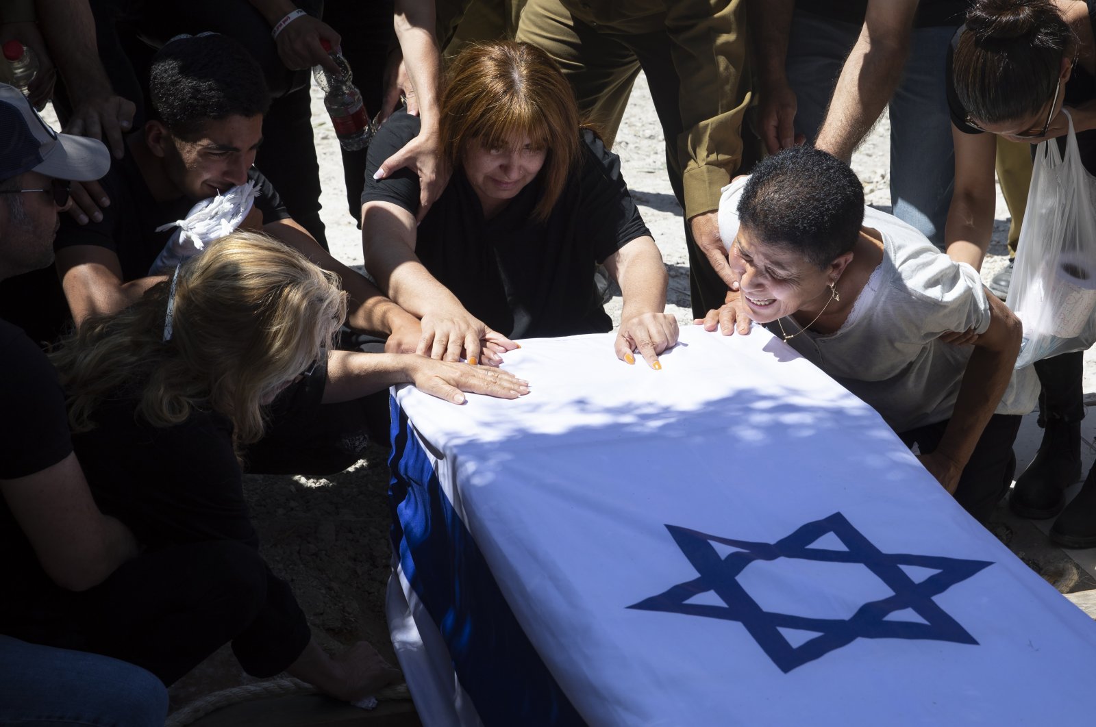 Relatives of Israeli soldier Omer Tabib, 21, mourn during his funeral at the cemetery in the northern Israeli town of Elyakim, Thursday, May 13, 2021. (AP Photo)