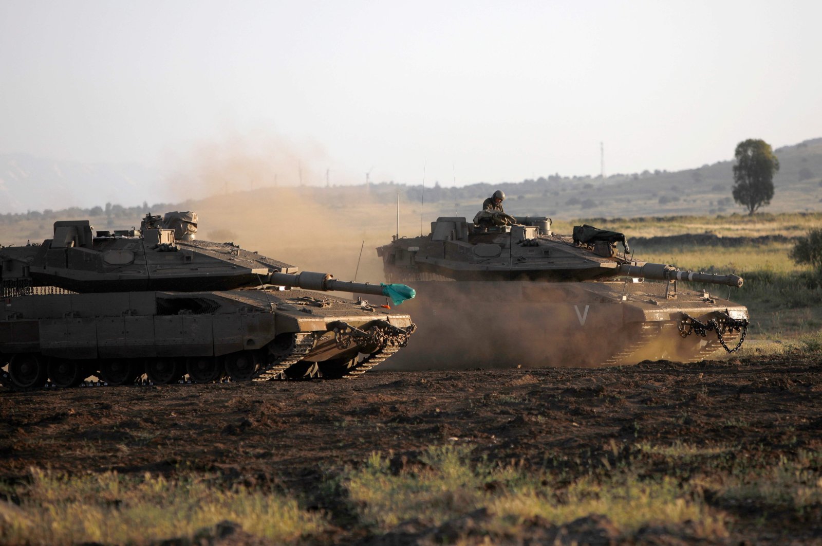 Israeli soldiers ride in Merkava Mark IV battle tanks near Moshav Alonei HaBashan in the Israeli-occupied Golan Heights, April 29, 2021. (AFP Photo)
