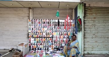 An Indian woman sells face masks near a closed market during the coronavirus pandemic far north of Kolkata, eastern India, May 12, 2021. (EPA Photo)