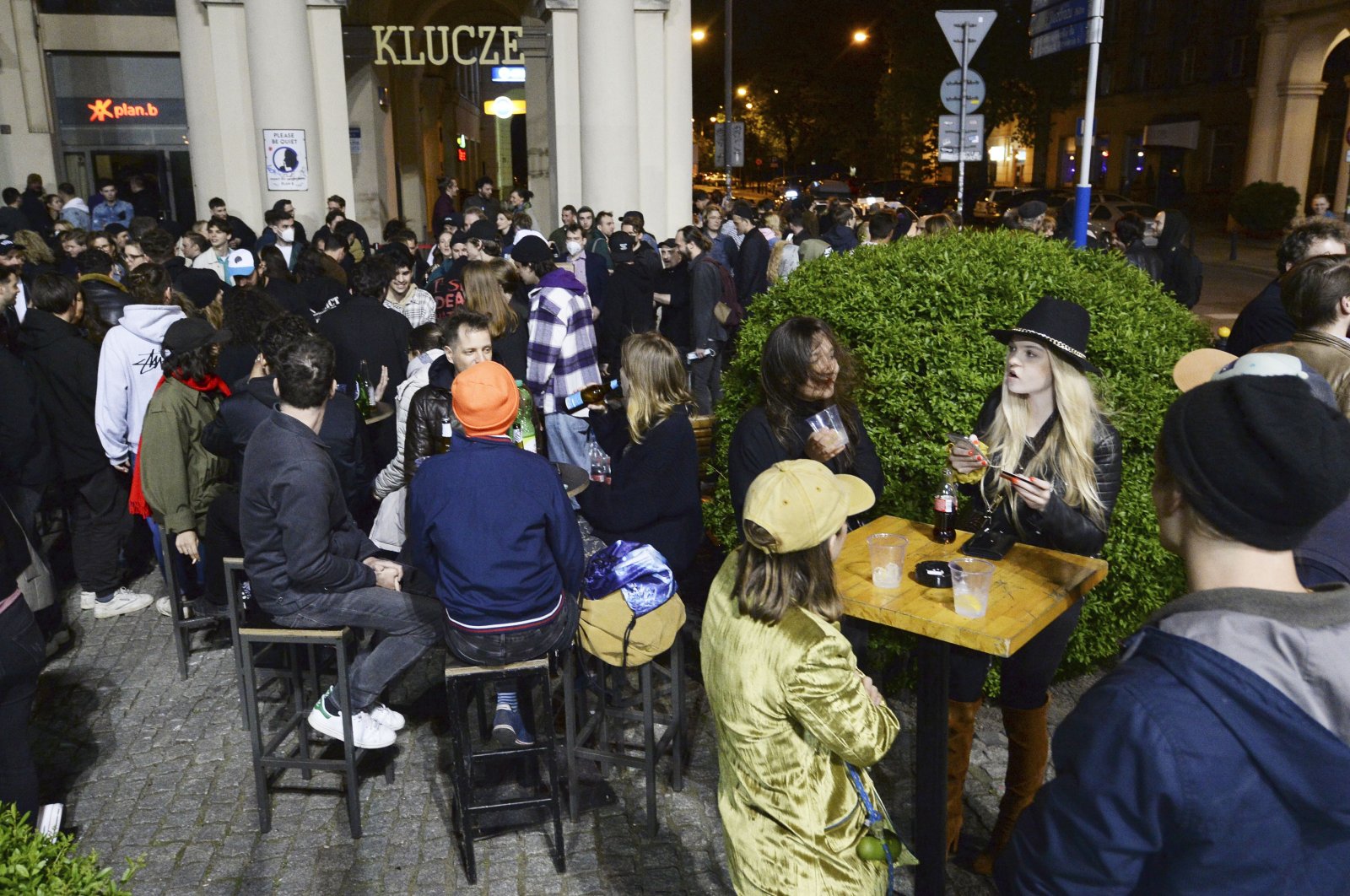 People gather and celebrate as bars, clubs and other establishments reopened in Poland after being closed for seven months, in Warsaw, Poland, May 14, 2021. (AP Photo)