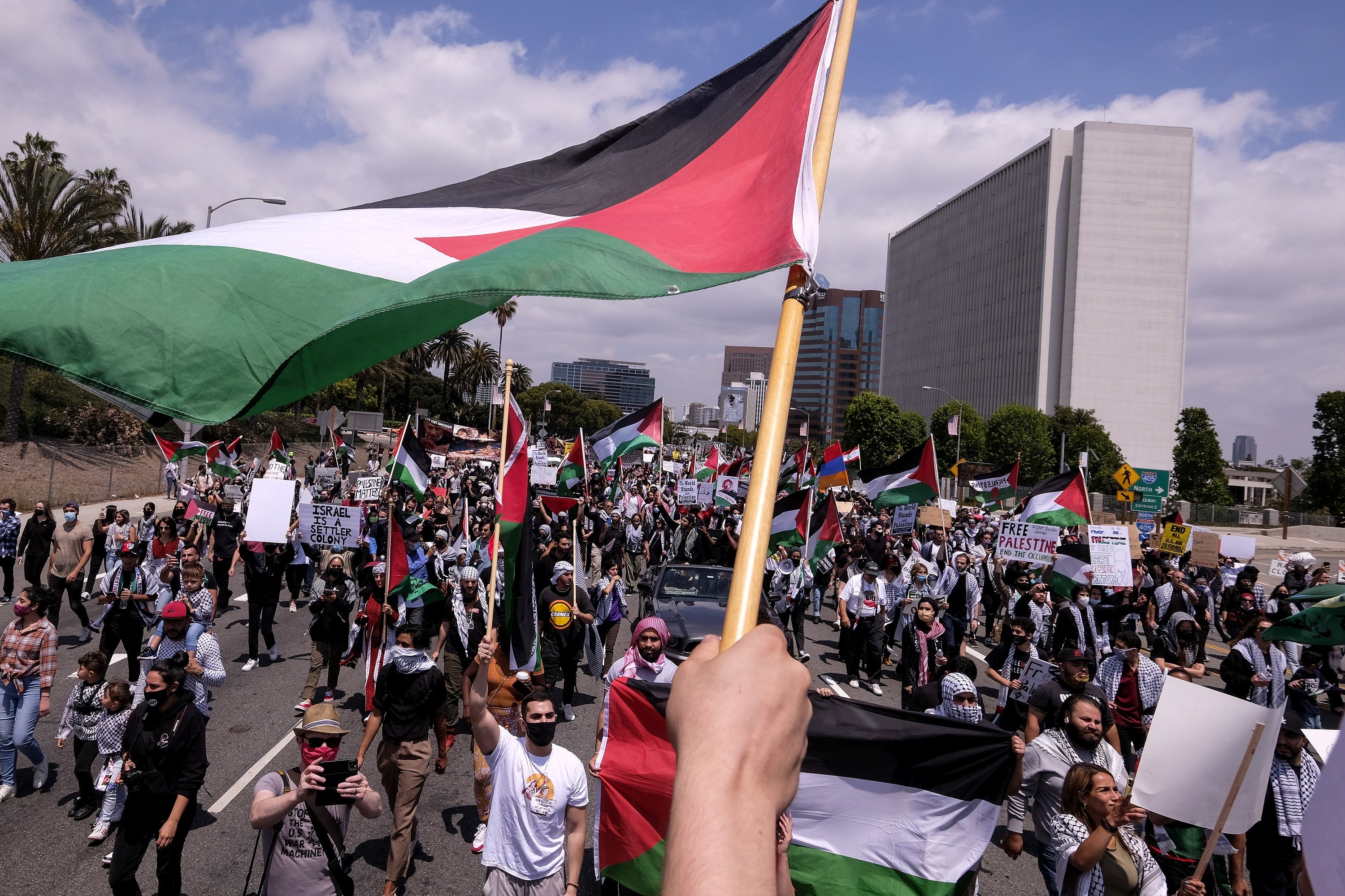 Demonstrators holding signs march to Israeli Consulate during a protest against Israel and in support of Palestinians, in Los Angeles, U.S., May 15, 2021. (AP Photo)