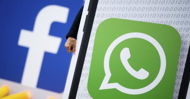 Activists of the campaign network Campact demonstrate against new terms of use of the communication app "WhatsApp" in front of the Hamburg HQ of internet company Facebook, Hamburg, Germany, Friday, May 14, 2021. (AP Photo)