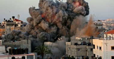 A ball of fire and thick smoke erupts following an Israeli bombardment on a building in Gaza City's Rimal residential district, Palestine, May 16, 2021. (AFP Photo)