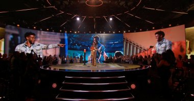 Yara Shahidi speaks, as images of the late Chadwick Boseman are projected, during the 2021 MTV Movie & TV Awards in Los Angeles, California, U.S., May 16, 2021. (Viacom via Reuters)