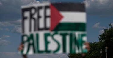 An activist holds up a sign with the U.S. Capitol in the background, in support of Palestine, near the Washington Monument in Washington, D.C., U.S., May 15, 2021. (AFP Photo)