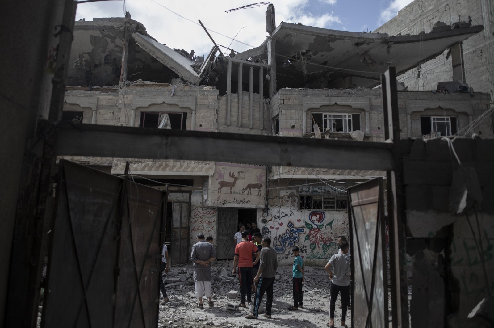 Palestinians inspect a damaged house that was hit by early morning Israeli airstrikes, in Gaza City, Palestine, May 17, 2021. (AP Photo)