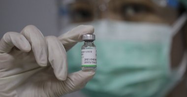 A health care worker shows a Sinopharm COVID-19 vaccine vial during the first day of a private vaccination drive for workers at Indah Kiat Pulp and Paper Company, part of Sinar Mas Group in Tangerang, outskirt of Jakarta, Indonesia, May 18, 2021. (EPA Photo)
