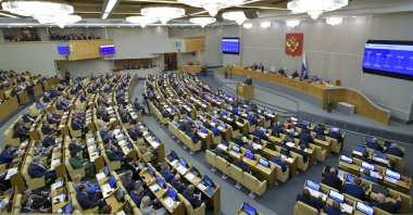 Russian Prime Minister Mikhail Mishustin, foreground on a podium, speaks at the State Duma, the Lower House of the Russian Parliament, with an annual report on the country's economic and social development, in Moscow, Russia, Wednesday, May 12, 2021. (AP Photo)
