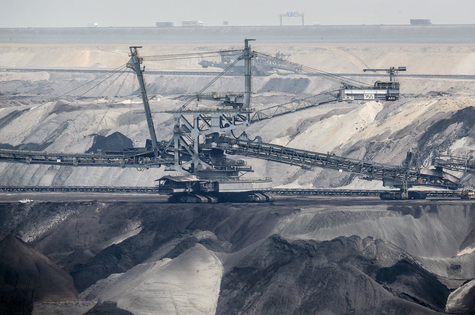 Giant bucket-wheel excavators extract coal at the controversial Garzweiler surface coal mine near Jackerath, western Germany, April 29, 2021. (AP Photo)