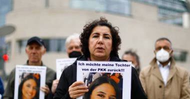 Mother Maide T. holds a photo of her daughter during a protest in front of the Chancellory in Berlin, Germany, May 12, 2021. (AA Photo)