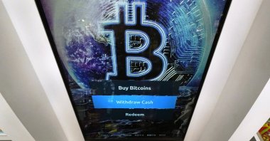 The Bitcoin logo appears on the display screen of a cryptocurrency ATM at the Smoker's Choice store in Salem, New Hampshire, U.S., Feb. 9, 2021. (AP Photo)
