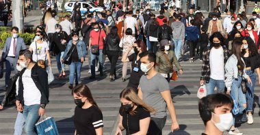 People wearing face masks walk on a street in the capital Ankara, Turkey, May 17, 2021. (AFP Photo)