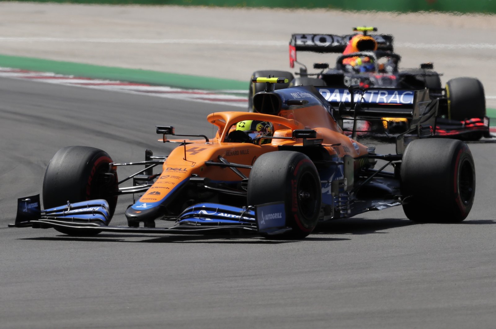Mclaren driver Lando Norris of Britain (front) takes a curve during the Portugal Formula One Grand Prix at the Algarve International Circuit near Portimao, Portugal, May 2, 2021. (AP Photo)
