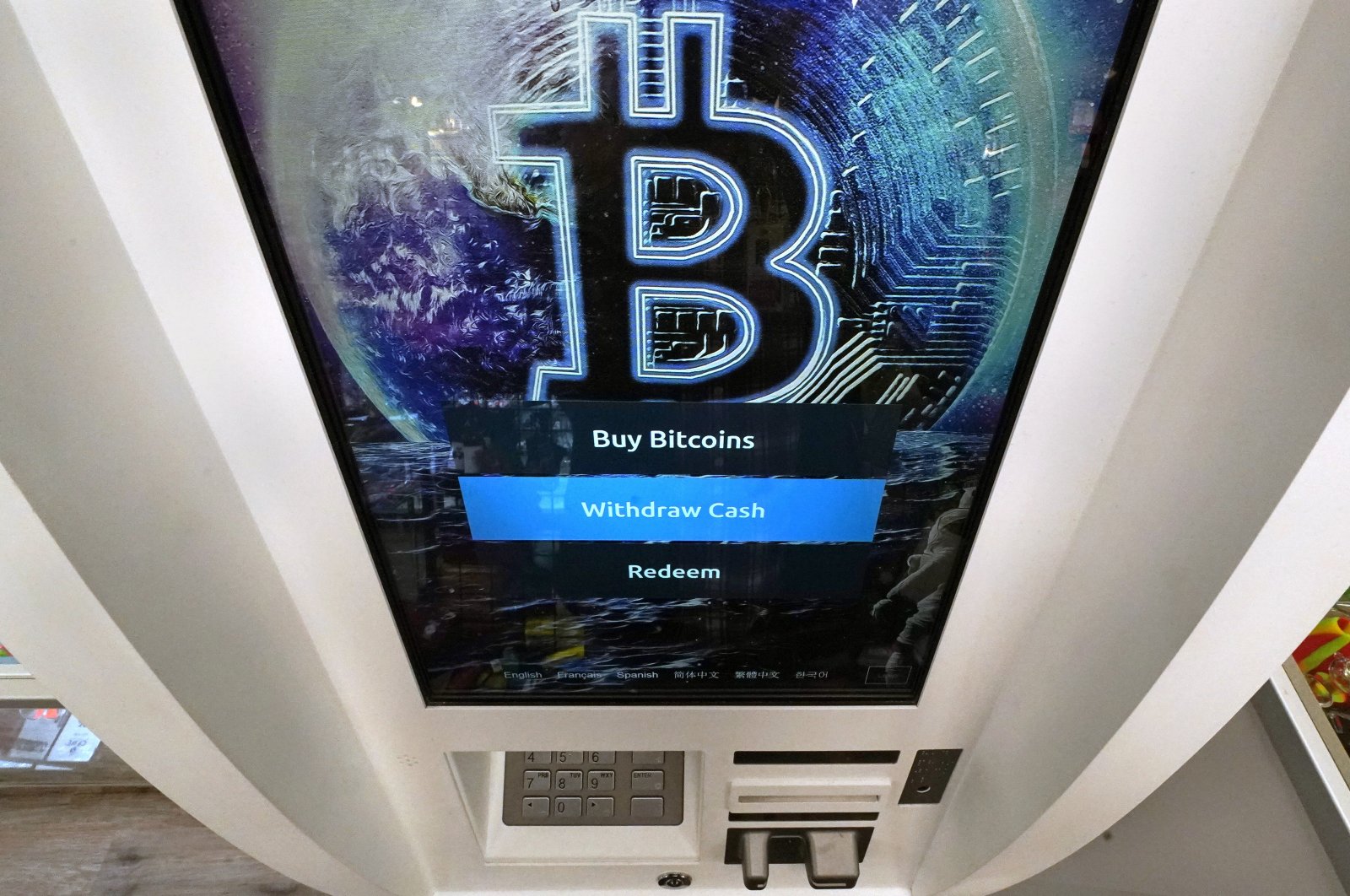 The Bitcoin logo appears on the display screen of a cryptocurrency ATM at the Smoker's Choice store in Salem, New Hampshire, U.S., Feb. 9, 2021. (AP Photo)