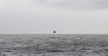 An Indian Navy Seaking helicopter evacuates stranded crew members from the sea after they were washed away from a barge that had gone adrift amidst heavy rain and strong winds of cyclonic storm Tauktae, May 19, 2021. (Indian Navy / AFP)