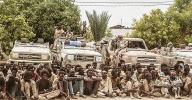 A group of captured rebels from the Front for Change and Concord in Chad (FACT) pose with their confiscated weapons and vehicles at the headquarters of the Chadian Army in N'Djamena, Chad, Central Africa, May 9, 2021. (AFP Photo)