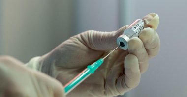 A nurse fills a syringe with the Pfizer Biontech vaccine at the vaccination center of German speciality chemicals company Evonik in Hanau, western Germany, on Mai 19, 2021, amid the ongoing coronavirus pandemic. (AFP Photo)