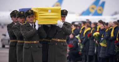 Soldiers carry a coffin containing the remains of one of the 11 Ukrainian victims of the Ukraine International Airlines flight 752 plane disaster during a memorial ceremony at the Boryspil International Airport, outside Kyiv, Ukraine, Jan. 19, 2020. (Ukrainian Presidential Press Service via Reuters)