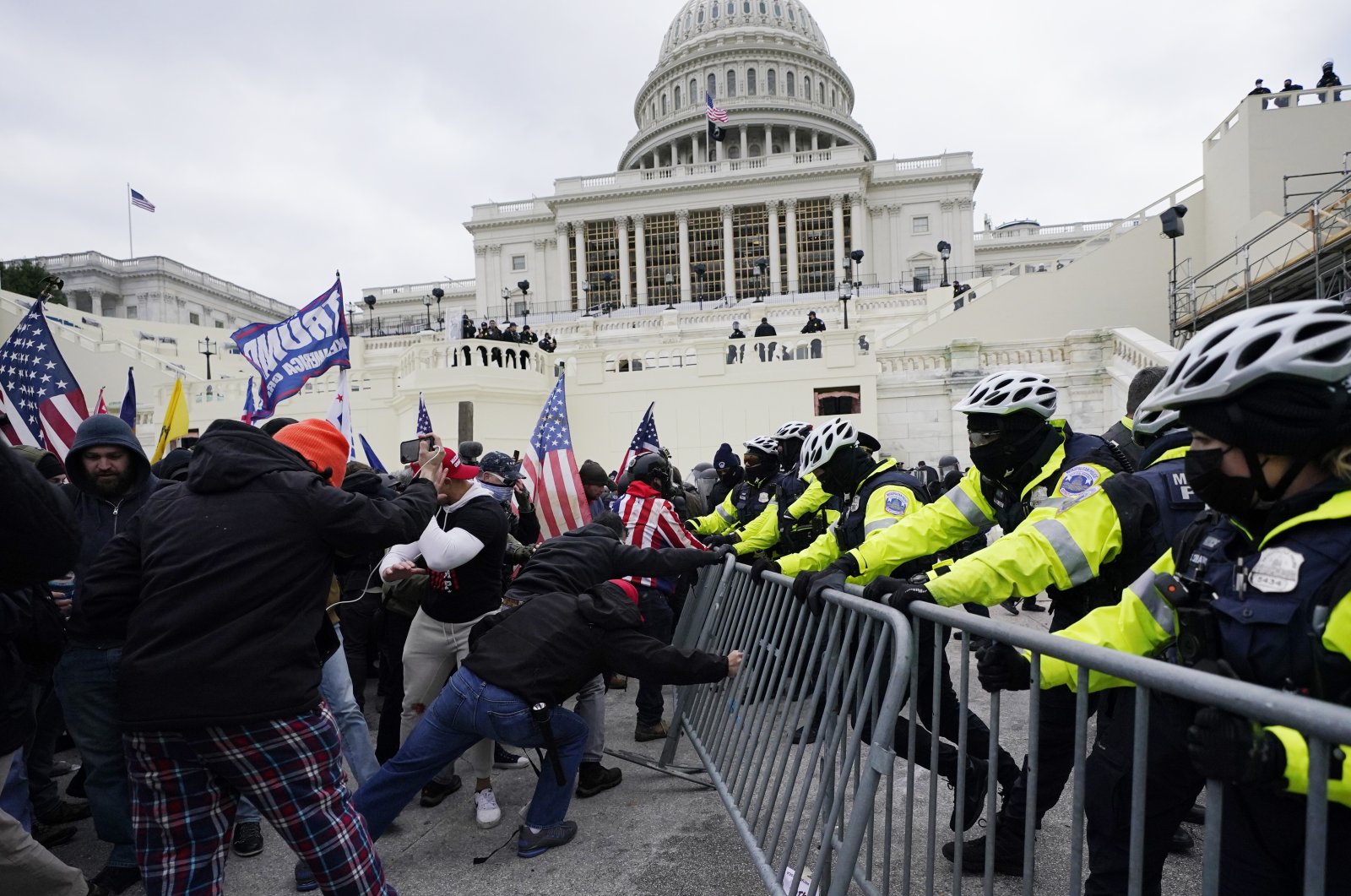 Trump supporters try to break through a police barrier at the Capitol in Washington, U.S., Jan. 6, 2021. With riot cases flooding into Washington’s federal court, the Justice Department is under pressure to quickly resolve the least serious cases. (AP Photo)