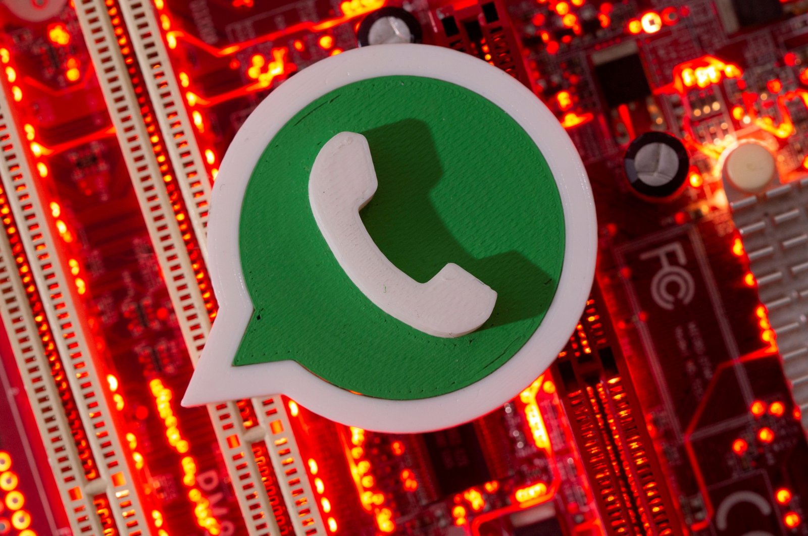 A 3D printed WhatsApp logo is placed on a computer motherboard in this illustration taken Jan. 21, 2021. (Reuters Photo)