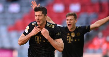 Bayern Munich's Polish forward Robert Lewandowski celebrates scoring his team's fifth goal and his 41st season goal during the German first division Bundesliga football match against FC Augsburg in at Allianz Arena in Munich, southern Germany, May 22, 2021. (Photo by Christof Strache/DFL/Pool via AFP)