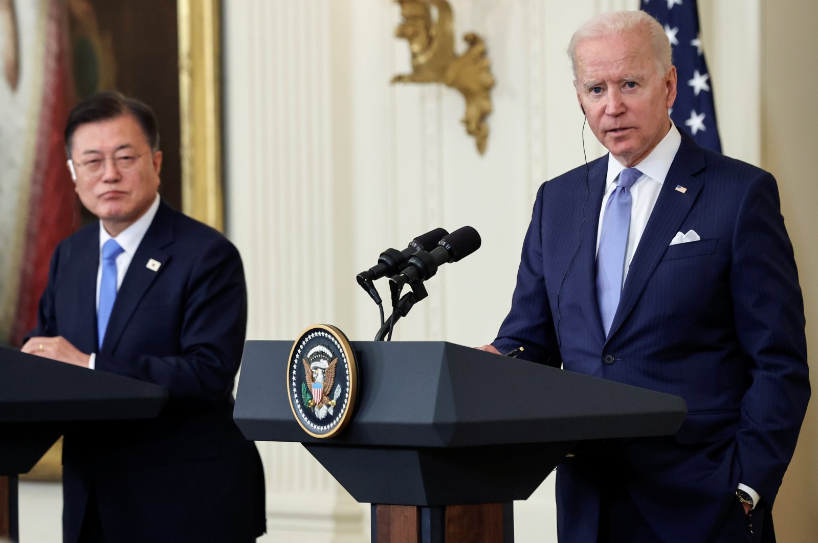 South Korean President Moon Jae-in (L) listens while U.S. President Joe Biden engages a reporter during a joint news conference after a day of meetings at the White House, in Washington, D.C., U.S., May 21, 2021. (REUTERS)