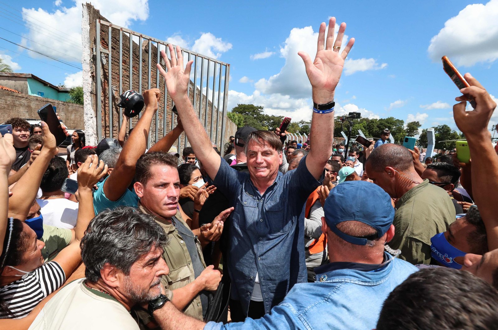 President Jair Bolsonaro greets a crowd during a non-scheduled visit to the city of Senador La Rocque, Maranhao state, Brazil, on May 21, 2021. (AFP Photo)
