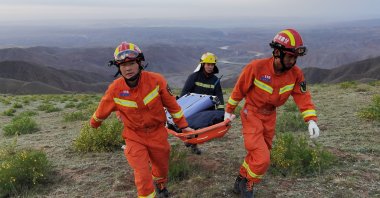 Rescue workers carry a stretcher as they work at the site where extreme cold weather killed participants of a 100-kilometer ultramarathon race in Baiyin, Gansu province, China, May 22, 2021. (Cnsphoto via Reuters)