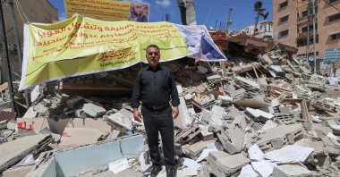 Samir Mansour, Palestinian owner of the eponymous bookstore and publishing house that had the largest collection of English literature in Gaza, standing in front of the rubble of his bookshop after it was destroyed by Israeli airstrikes, Gaza City, Palestine, May 22, 2021 (AFP Photo)