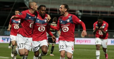 Lille's Burak Yılmaz (L) celebrates a goal with Renato Sanches (C) and Yusuf Yazıcı during the Ligue 1 match against Angers, in Angers, France, May 23, 2021. (EPA Photo)