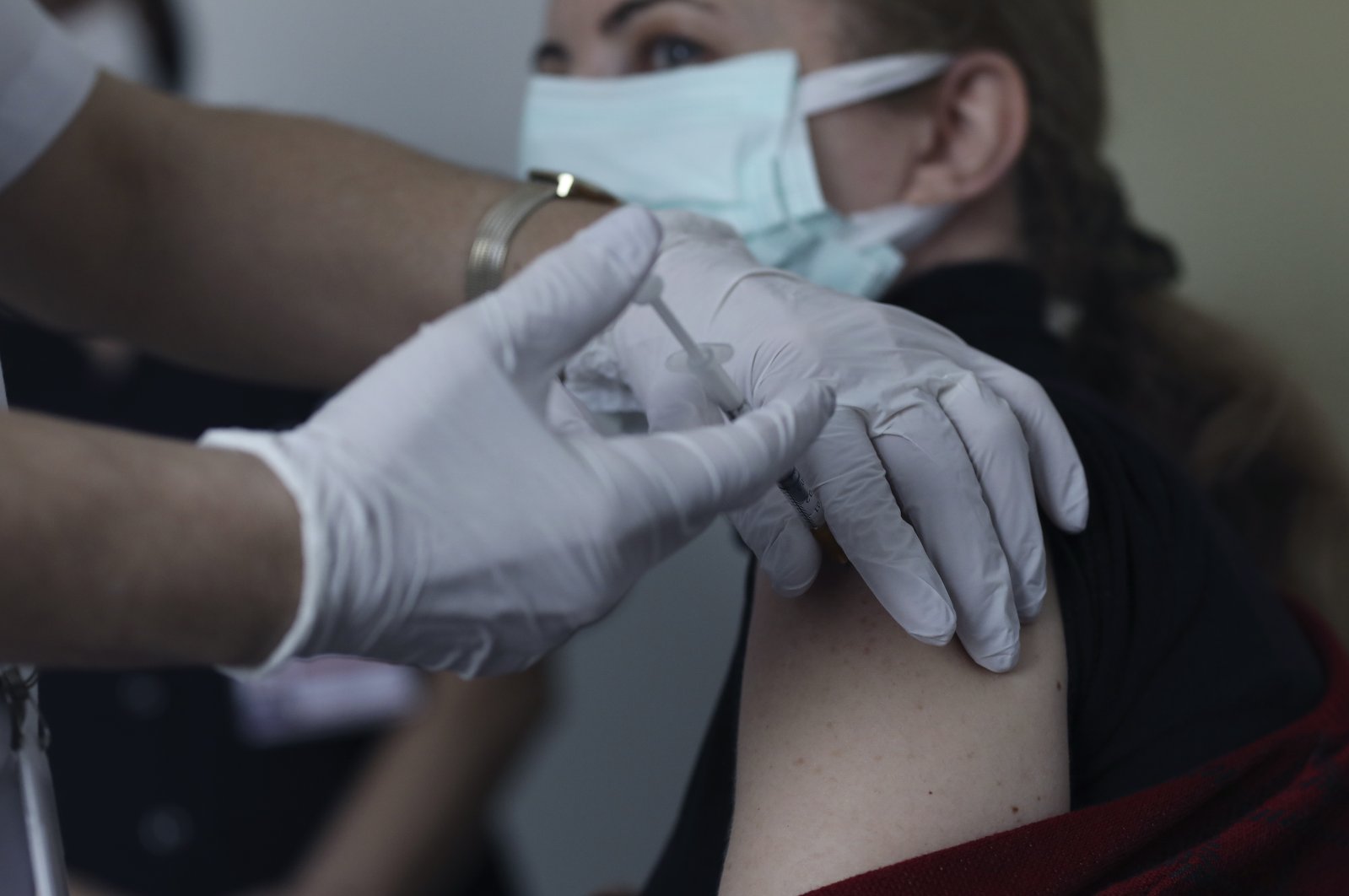 Nurse Hülya Şahin administers the Pfizer-BioNtech COVID-19 vaccine to a person at a hospital in Ankara, Turkey, Saturday, April 3, 2021. (AP Photo)