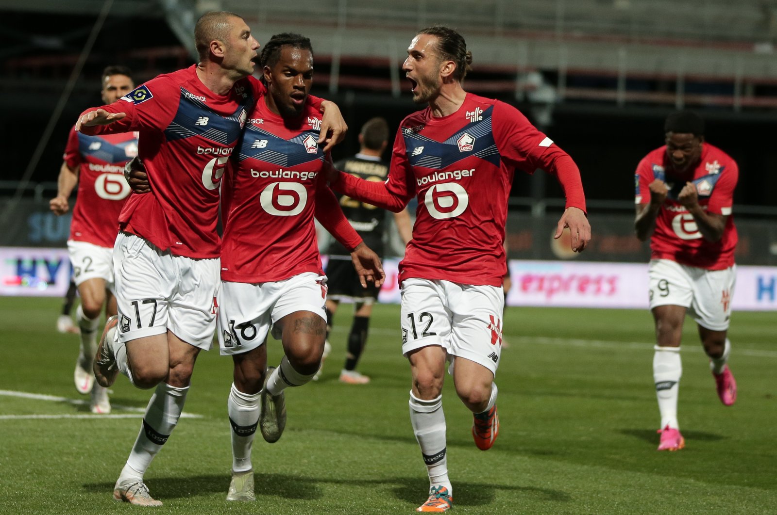 Lille's Burak Yılmaz (L) celebrates a goal with Renato Sanches (C) and Yusuf Yazıcı during the Ligue 1 match against Angers, in Angers, France, May 23, 2021. (EPA Photo)