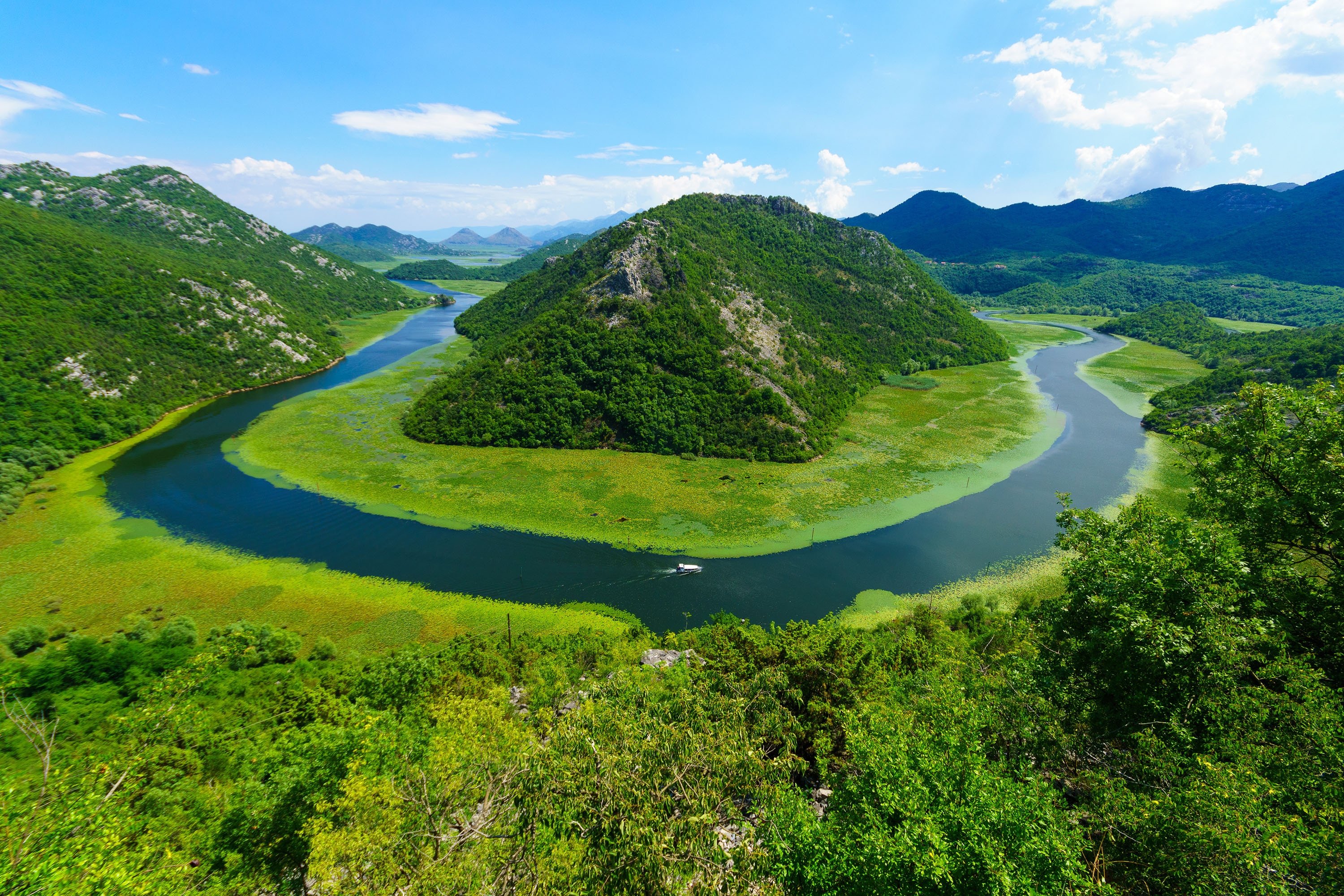 Rijeka Crnojevica River bends around Green Pyramid hill in the northern area of Skadar Lake National Park, Montenegro. (Shutterstock Photo)