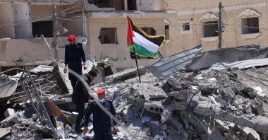 Palestinian police officers walk amid the rubble following a cease-fire in Gaza City, Gaza Strip, Palestine, on May 22, 2021. (AFP Photo)