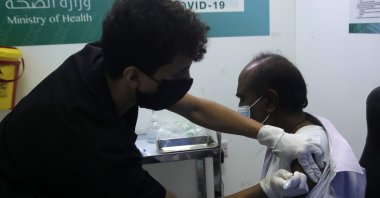 A Saudi physician administers a Pfizer coronavirus vaccine to a man at a vaccination center in the old Jeddah airport, Saudi Arabia, May 18, 2021. (AP Photo)