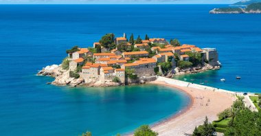 The small islet of Sveti Stefan stands surrounded by the waters of the Adriatic Sea in western Montenegro. (Shutterstock Photo)