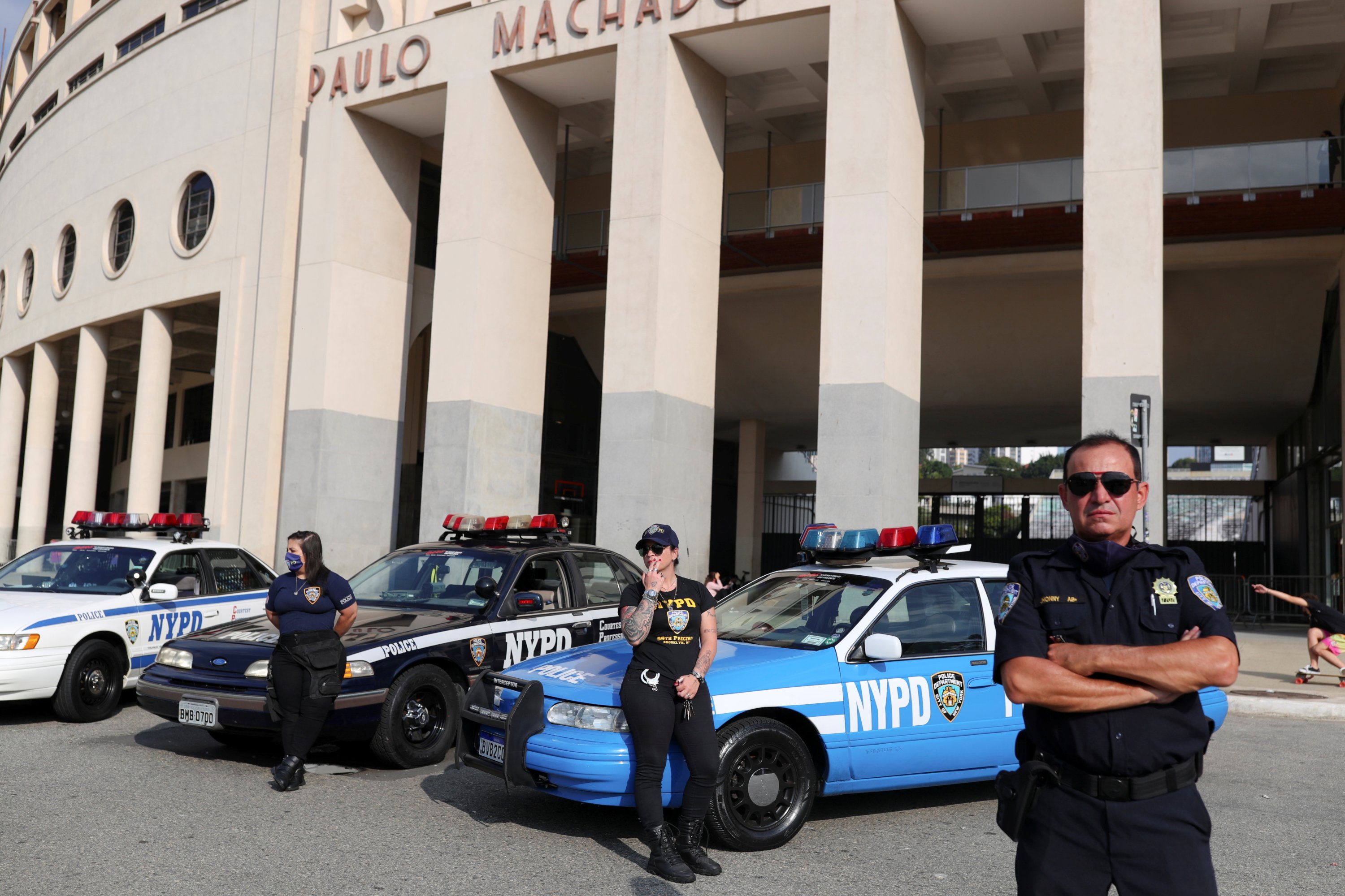 Brazilian fans of the New York Police Department (NYPD) Mariani Morandi, Michelle Grasso and Jhonny Brito stand in front of Pacaembu Stadium in Sao Paulo, Brazil, May 16, 2021. (Reuters Photo)