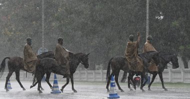 Mounted police ride on their horses along a road during rainfall in Kolkata, India, May 24, 2021. (AFP Photo)