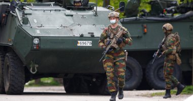 Members of the Belgian army are seen near the entrance of National Park Hoge Kempen while scouring the region for Jurgen Conings, a soldier who disappeared after threatening a virologist supportive of COVID-19 vaccines and coronavirus restrictions, in Maasmechelen, Belgium, May 20, 2021. (Reuters Photo)