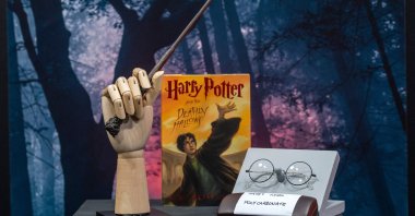 Harry Potter's wand and eyeglasses are displayed next to a copy of "Harry Potter and the Deathly Hallows" during a press preview of Prop Store's Iconic Film & TV Memorabilia in Valencia, California, May 14, 2021. (AFP Photo)