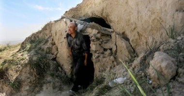 Shepherd Zhu Keming, hailed as a hero in China for rescuing six ultramarathon runners when extreme weather hit the area leaving at least 21 dead, shows the cave-dwelling where he sheltered the stricken athletes near the city of Baiyin, in China's northwestern Gansu province, May 24, 2021. (AFP Photo)